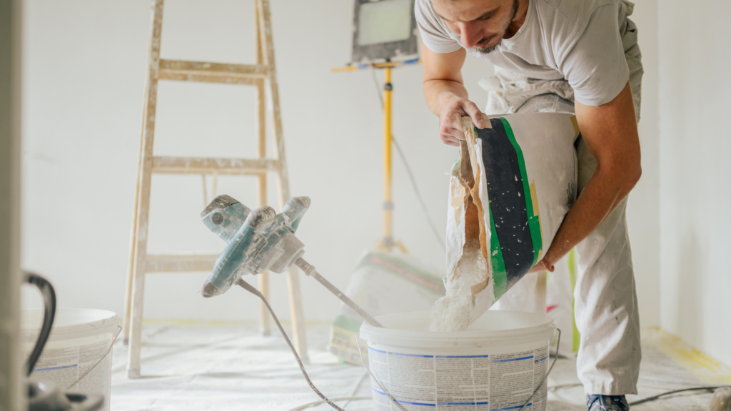man-preparing-plaster-in-renovated-interior-home-2026-